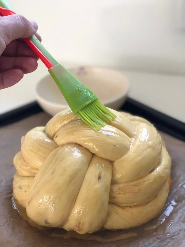 Po dokynutí potřete mazanec rozšlehaným vajíčkem a posypte cukrem